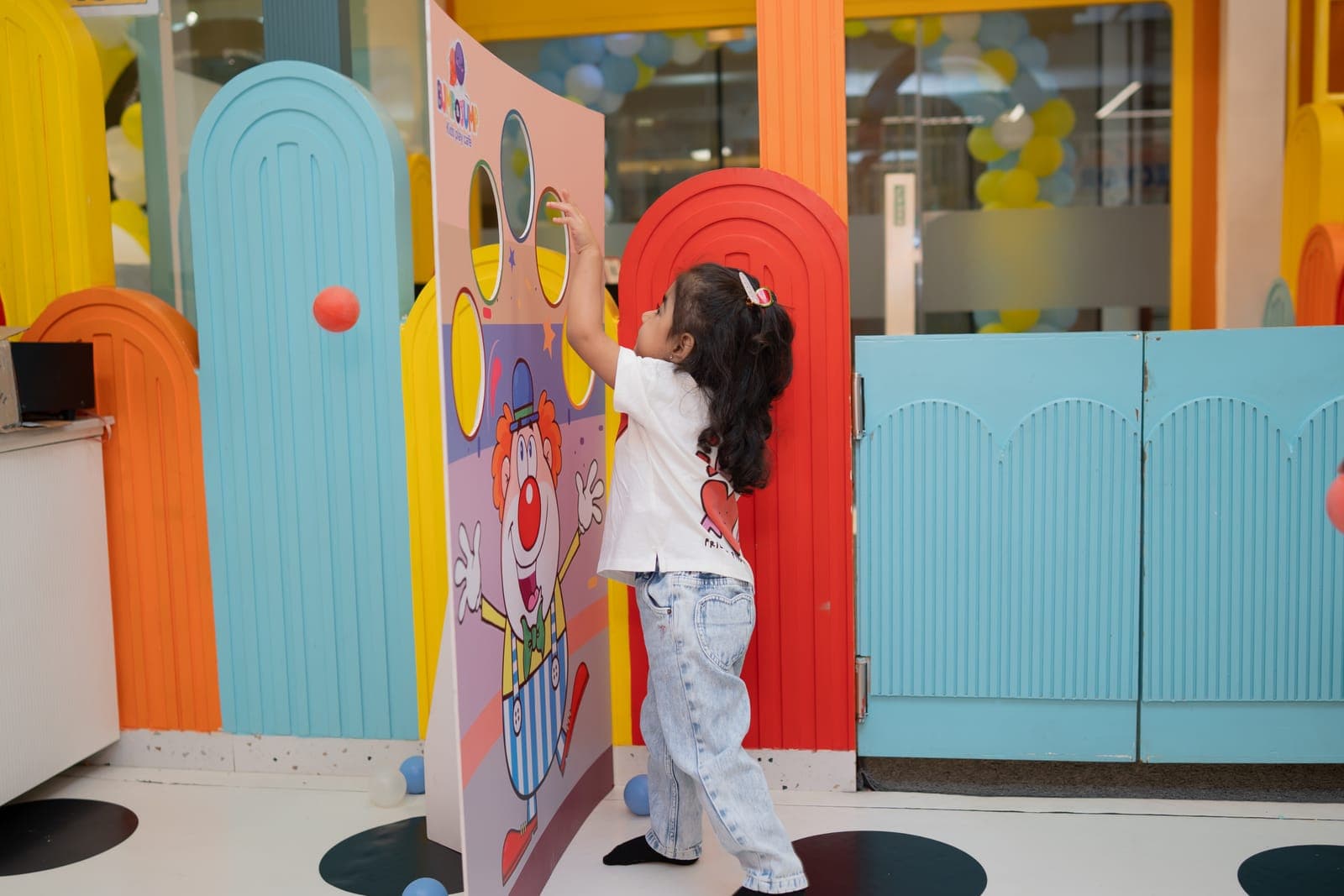 Girl playing the clown ball-toss game